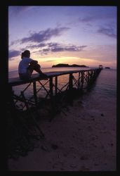 The pier on kadidiri Indonesia points to two islands over... by Andrew Woodburn 