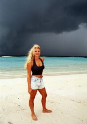 Claudia and the Cyclone cloud, Maldives.  by Leon Joubert 