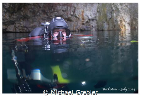 Cave diver at the surface of a flooded mine, near Bucking... by Michael Grebler 