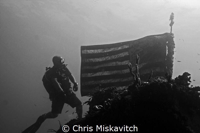 Diver and American flag on the wreck of the Spiegel Grove. by Chris Miskavitch 