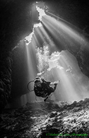 Cathedral lighting illuminates diver inside a cave at St ... by Gabriel De Leon Jr 
