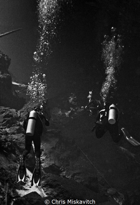 Divers exporing the Cenote by Chris Miskavitch 