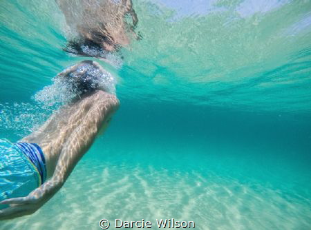This photo is taken of my boyfriend diving under a wave. ... by Darcie Wilson 