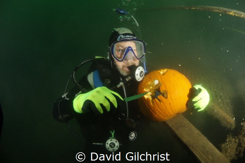 Diver works to carve a pumpkin underwater at the Welland ... by David Gilchrist 