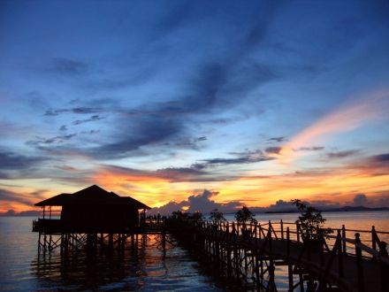 Sunset over cosy water chalets of Kapalai. Waves for song... by Lillian Khoo 