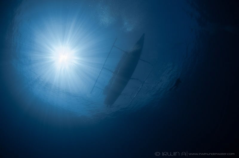 B L U E 😊
Shark point - Sunlight, Boat & Diver 
Lombok... by Irwin Ang 