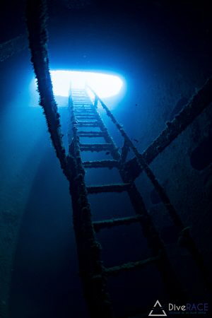 Taken within Igara wreck. The stairway up onto the deck a... by Lionel Lim 
