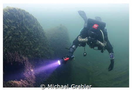 Rebreather diver at the boilers of the wreck of the Rothe... by Michael Grebler 