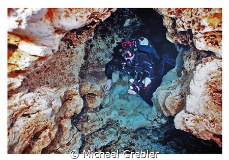 Cave diver passing through the keyhole rock formation in ... by Michael Grebler 