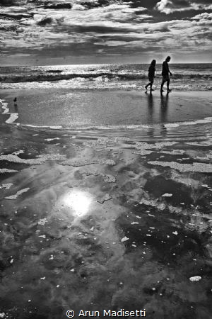 A day at the beach. People walking the surf line at Myrtl... by Arun Madisetti 