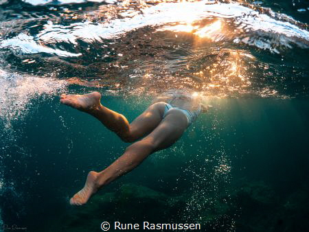 Swimming under Mediterranean sunset by Rune Rasmussen 