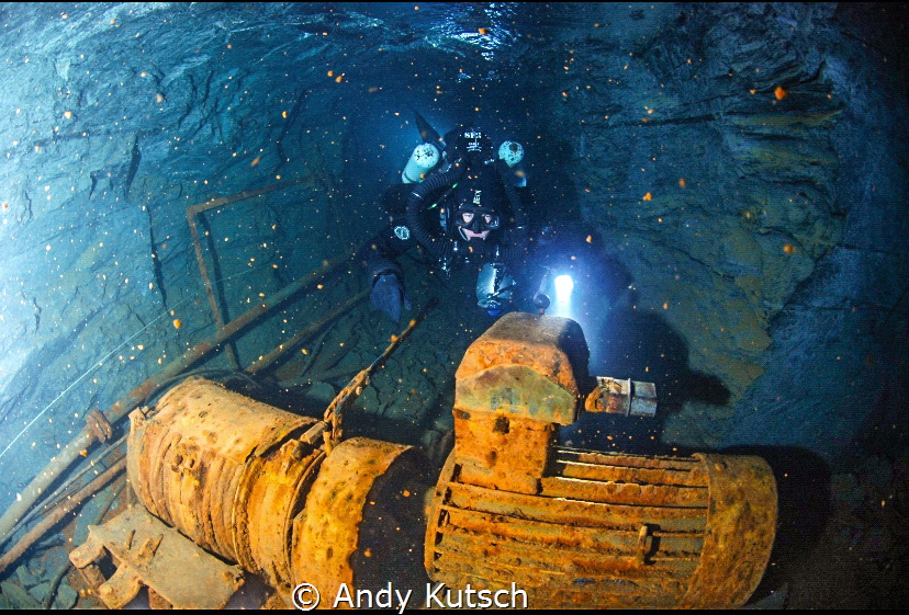 Diver on the way back in the slate mine nuttlar in Germany by Andy Kutsch 