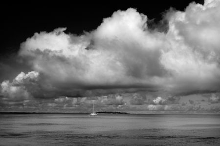 Gathering Storm. A sailboat in the Kwajalein Lagoon by Lee Craker 