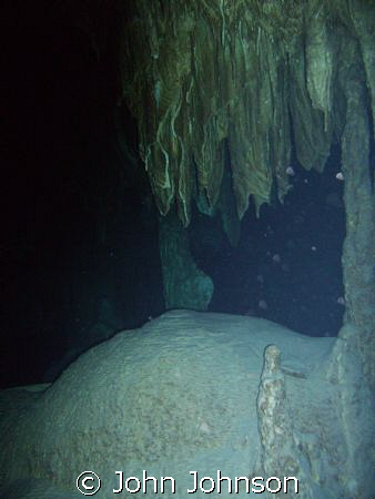 this is inside the cenote, it was dark but not pith black... by John Johnson 