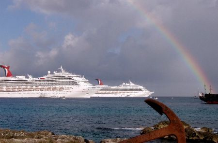 beautiful rainbow shines over the Grand Cayman port after... by Andrew Kubica 