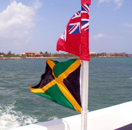 Cayman Islands and Jamaican flags displayed on the Ray Ex... by Andrew Kubica 