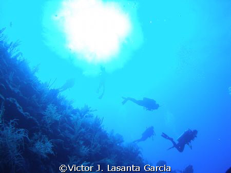 divers descending from the sun at two for you dive site i... by Victor J. Lasanta Garcia 