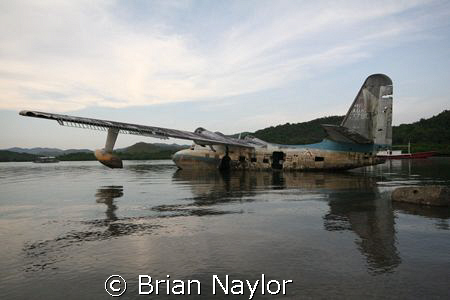 plane rotting on the surface crying out to be sunk as a d... by Brian Naylor 