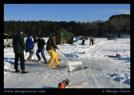 Pulling out part of the ice for the hole - for Ice Diving... by Margo Cavis 
