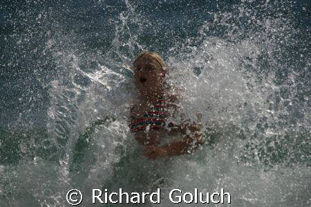 Splashing in water of the coast of Kauai after a dive. by Richard Goluch 