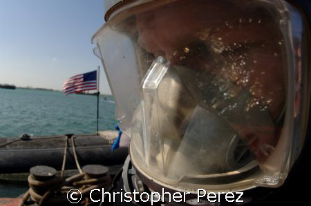 Navy Diver takes a moment to pray before entering the wat... by Christopher Perez 