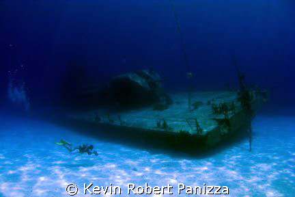 Videographer shooting the Shipwreck Tibbits in Cayman Bra... by Kevin Robert Panizza 