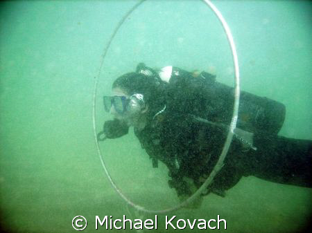 Student swimming through the hoops during a performance b... by Michael Kovach 