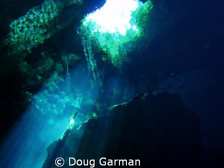 Cenote shot from about 20 feet up through hole in Jungle by Doug Garman 