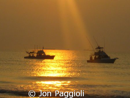 Bait fishing off Cocoa Beach at sunrise by Jon Paggioli 