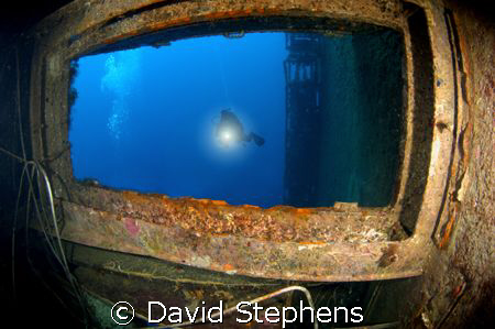 Shot of a diver on the wreck of the Zenobia. Taken with a... by David Stephens 