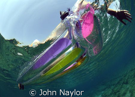girl on a lilo. by John Naylor 