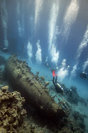 Divers (and bubbles) over the wreck in Abu Galawa. by Dray Van Beeck 