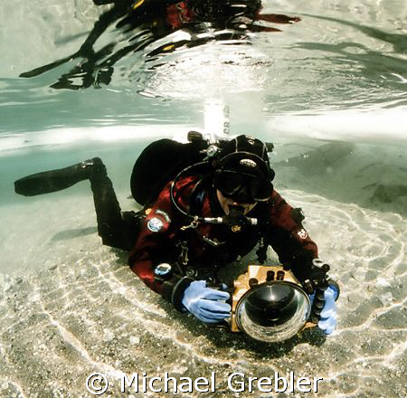 Diver with camera at the ice entry hole in Morrison's qua... by Michael Grebler 