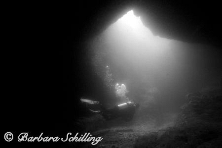 A diver leaving a cave by Barbara Schilling 