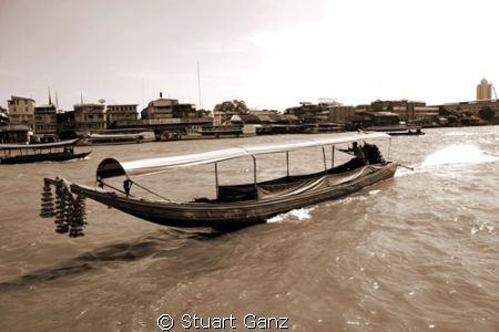 Longtail boat on the Chao Phraya river. by Stuart Ganz 