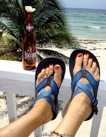Dive-flag toe nails, ankle bracelet, toe ring, Cuban beer... by William Goodwin 