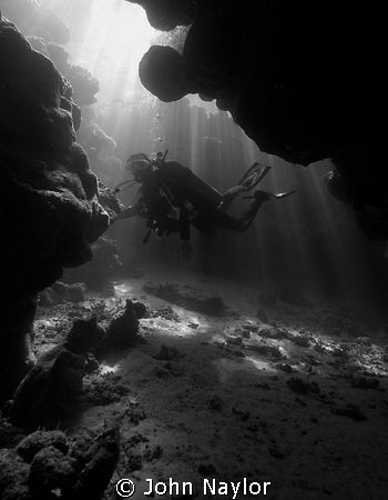 diver in cave by John Naylor 