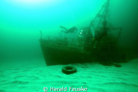 two divers exploring the wreck of viking jr. a small tugb... by Harald Fauske 