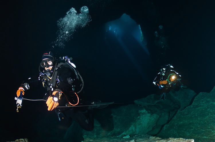 Divers enter the lower section of Kilsby's Sinkhole.  Dep... by Mick Tait 