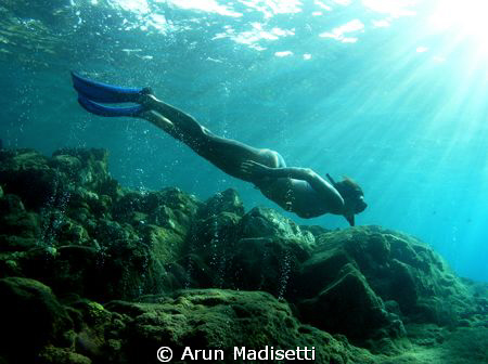 Snorkeler in the volcanic vents at Champagne by Arun Madisetti 