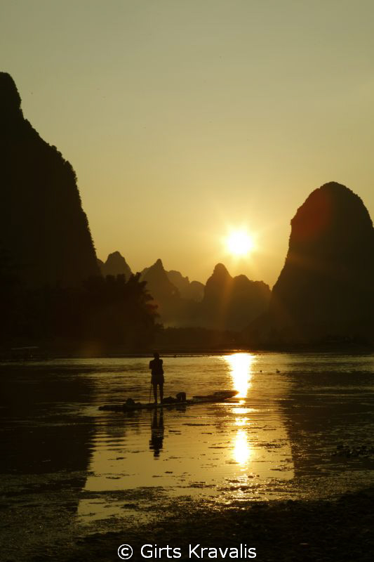 Fisherman on Li River by Girts Kravalis 