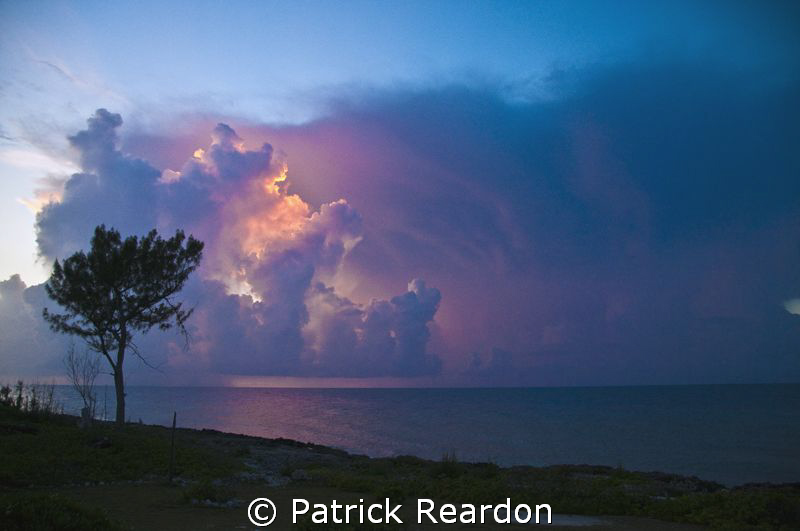 The setting sun lights up afternoon thunderheads on Grand... by Patrick Reardon 