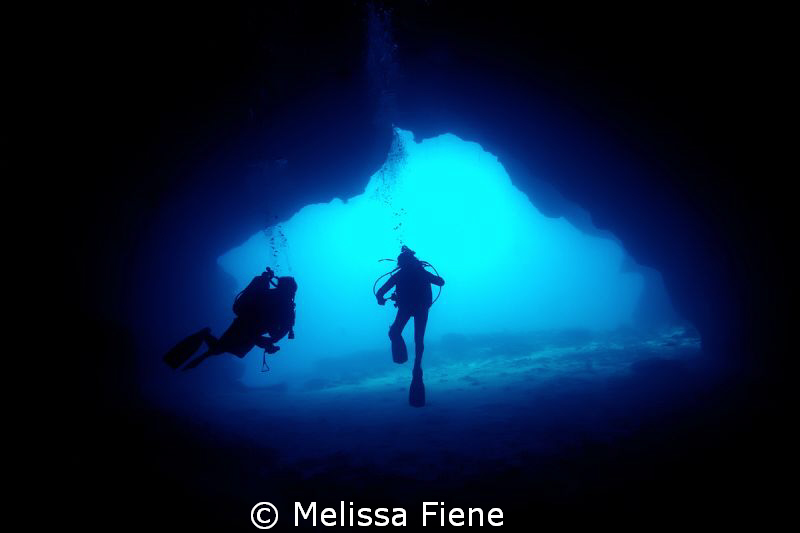 Image of divers in a cave, Vava'u Tonga. by Melissa Fiene 