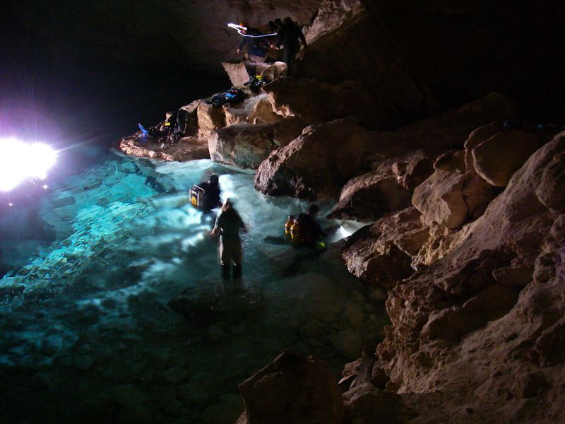 Divers get ready in the main chamber in Weebubbie Cave, n... by Mick Tait 