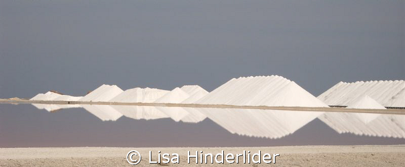 Reflections. Salt piles behind the drying ponds. Bonaire by Lisa Hinderlider 