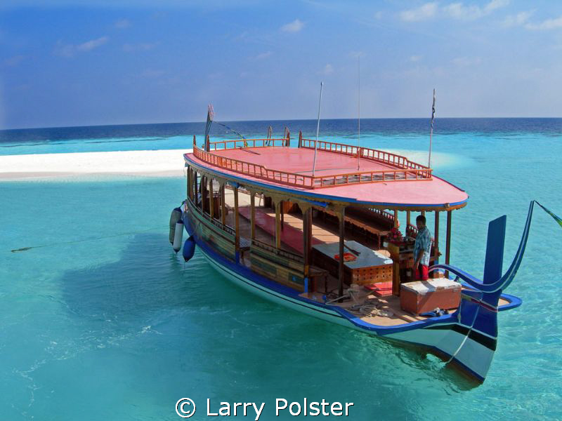 Dive boat, Angaga Island, beautiful clear waters by Larry Polster 