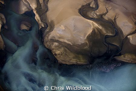 Aerial view from about 2000ft of the tide draining into t... by Chris Wildblood 