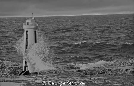 Bonaire's Lacre Punt Lighthouse at high tide - July 2010 by George Smorse 