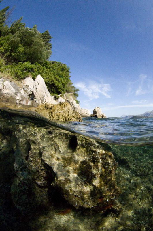 Split level of a Croatian rocky shore line.  Natural ligh... by Paul Colley 