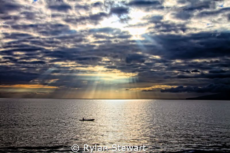 A lone canoe tried to beat the sunset in Maui. by Rylan Stewart 